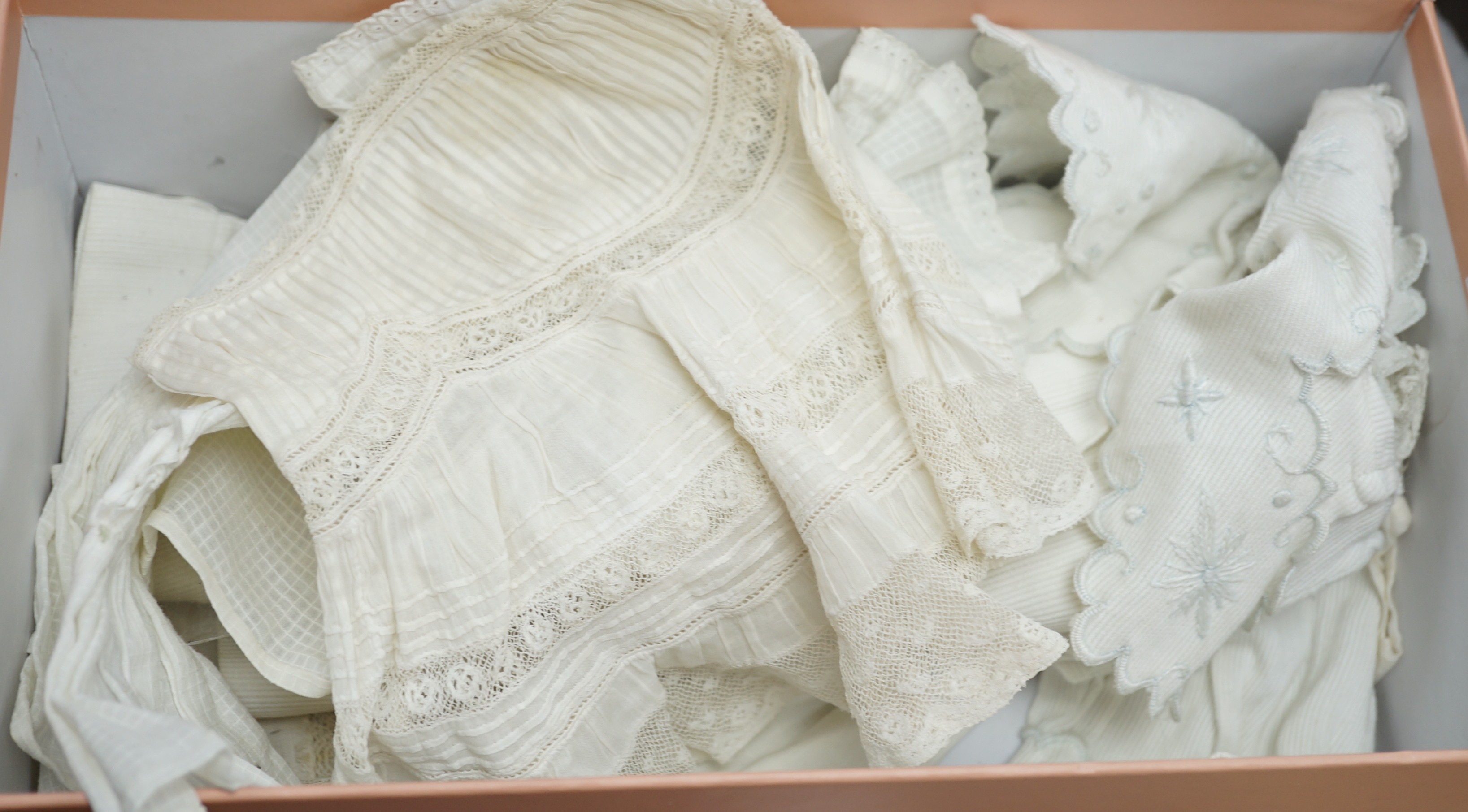 Assorted white cotton dolls dresses, petticoats, one coat and three hats and a child's shoe